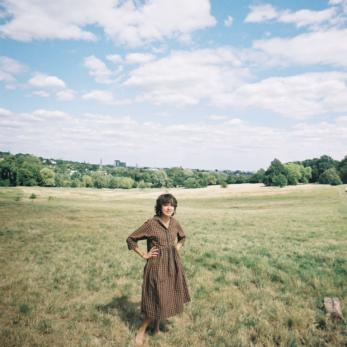 person in summer dress in field